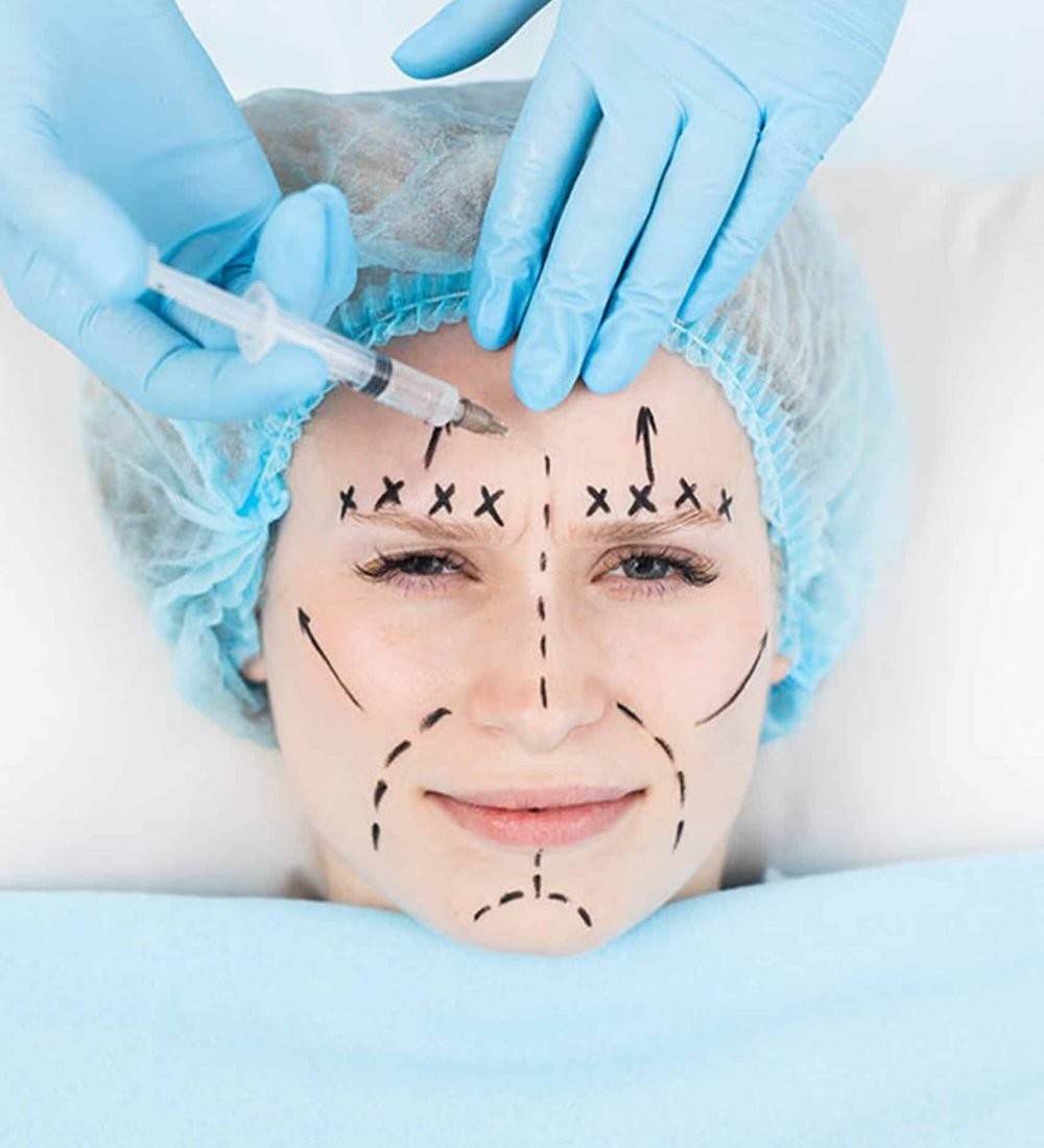 close-up plastic surgeon makes marks on a patient's face during a consultation before nose operation